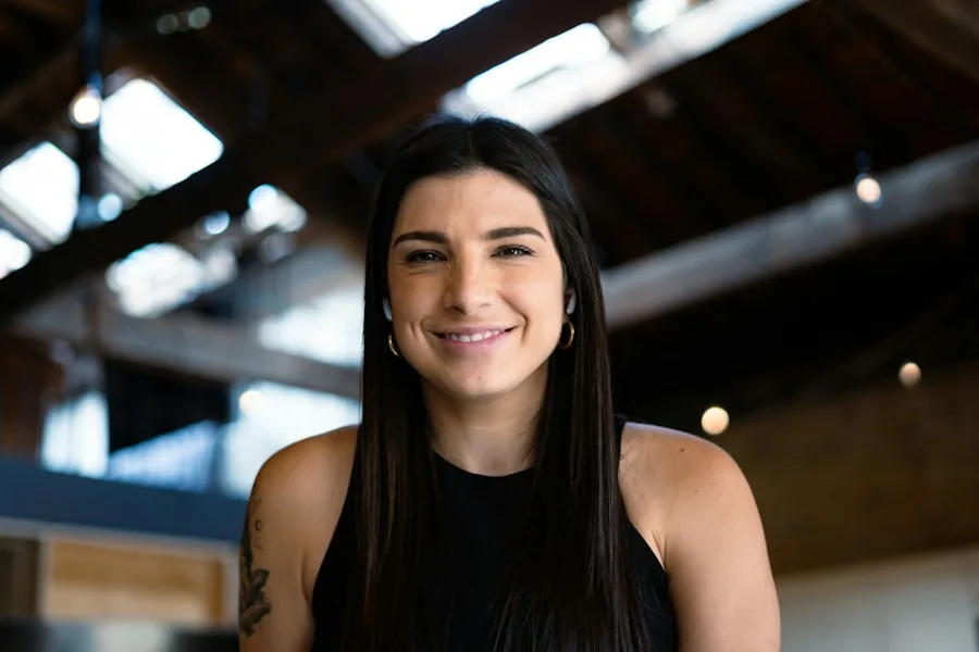 A professional smiling during a workplace conversation